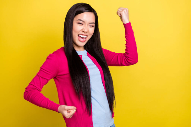 Photo of cheerful young happy nice woman winner fists celebrate luck isolated on shine yellow color background - Foto, Imagem