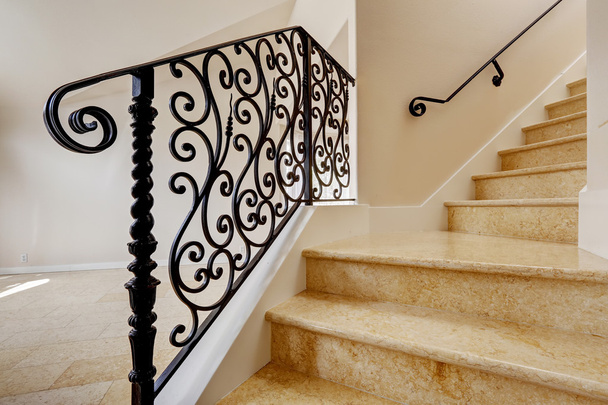 Marble staircase with black wrought iron railing - Photo, image