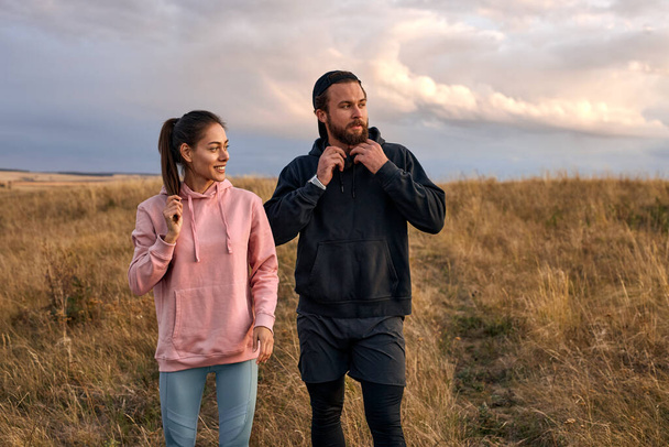 two athlete fit people getting ready to sport training outdoors, in field - Photo, image