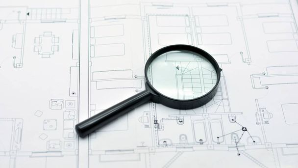 Concept of looking at a blueprint with a magnifying glass, architectural project - Фото, изображение