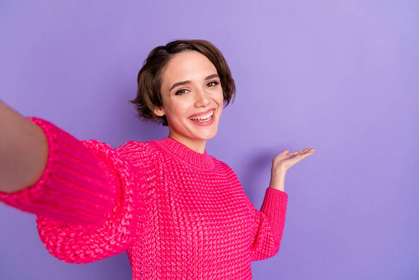 Portrait of charming person recording video arm indicate empty space isolated on pastel purple color background - Photo, Image