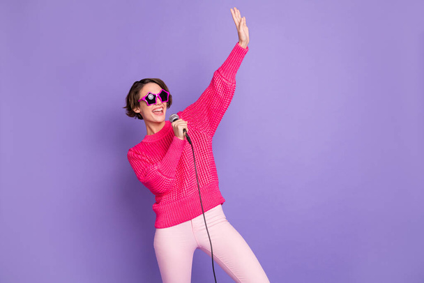 Photo of young attractive girl happy positive smile sing microphone karaoke isolated over violet color background - Φωτογραφία, εικόνα