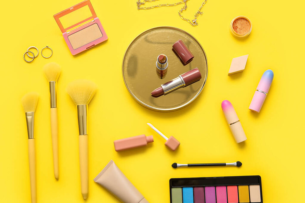 Decorative cosmetics on yellow background - Photo, Image