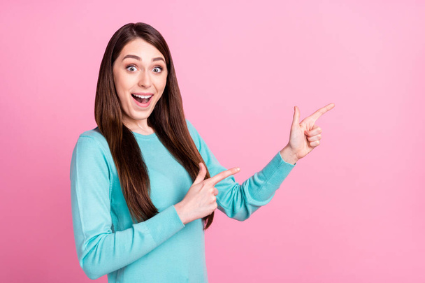 Photo of amazed shocked positive young woman point finger empty space isolated on pastel pink color background - Фото, изображение
