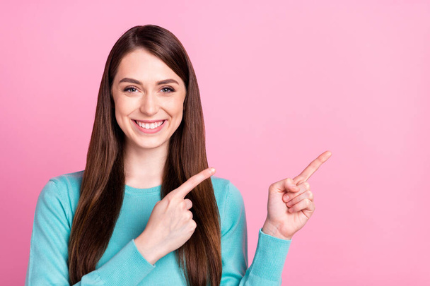 Portrait of attractive cheerful girl demonstrating copy space decision advert isolated over pink pastel color background - Foto, Bild