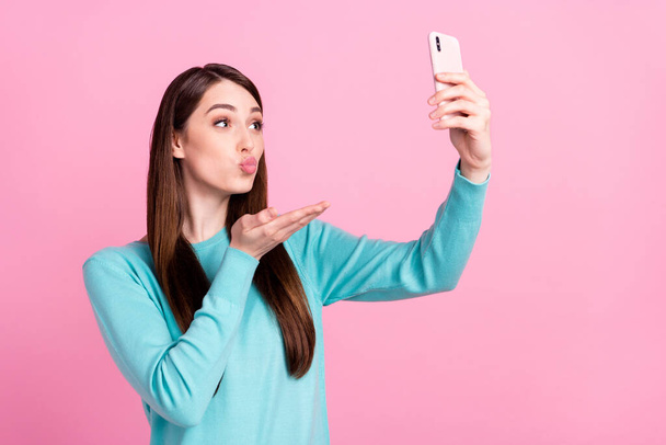 Photo portrait of girl taking selfie sending air kiss isolated on pastel pink color background - Photo, Image