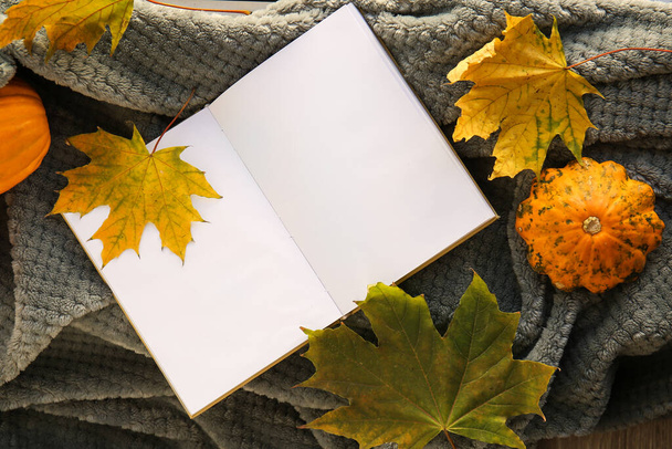 Blank book and autumn decor on plaid in room - Fotó, kép