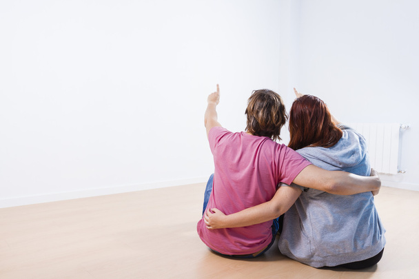 Young couple sitting in a room - Photo, Image