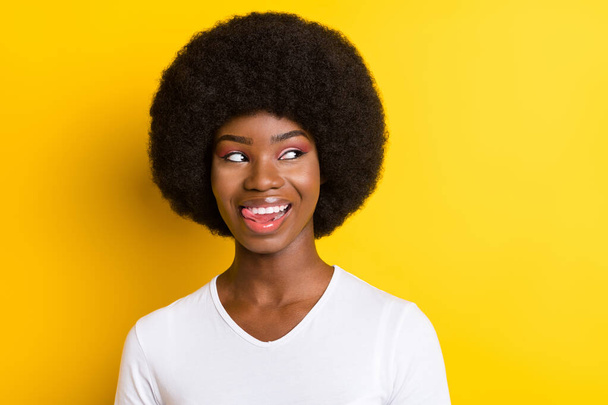 Photo of cheerful nice afro american young flirty woman look empty space dream isolated on yellow color background - Fotó, kép