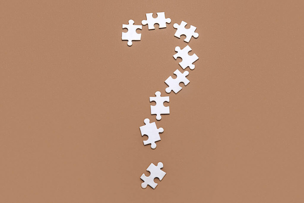 Question mark made of puzzles on color background - Photo, image