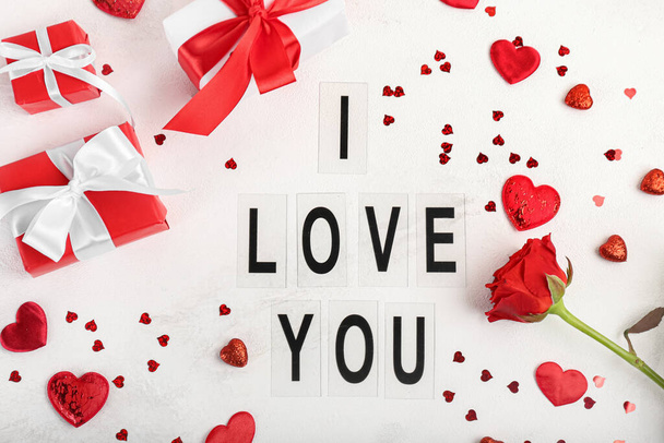 Text I LOVE YOU, rose flower and gifts for Valentine's Day on light background - Foto, imagen