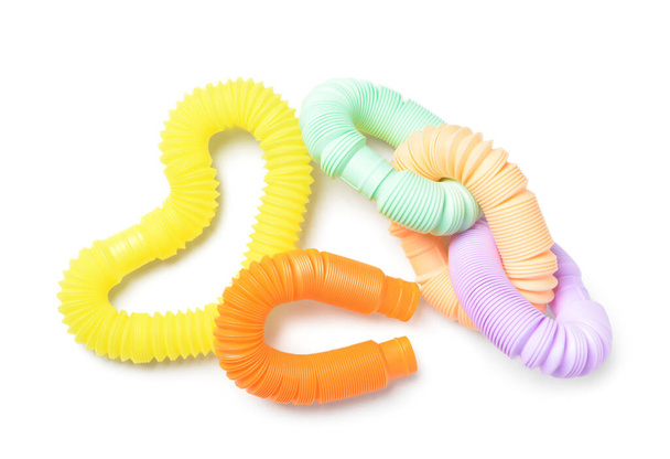 Different colorful Pop Tubes on white background - Foto, imagen