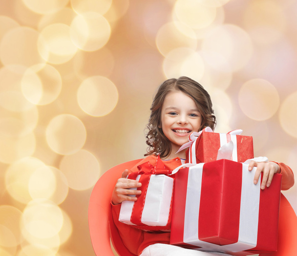 smiling little girl with gift boxes - Foto, imagen