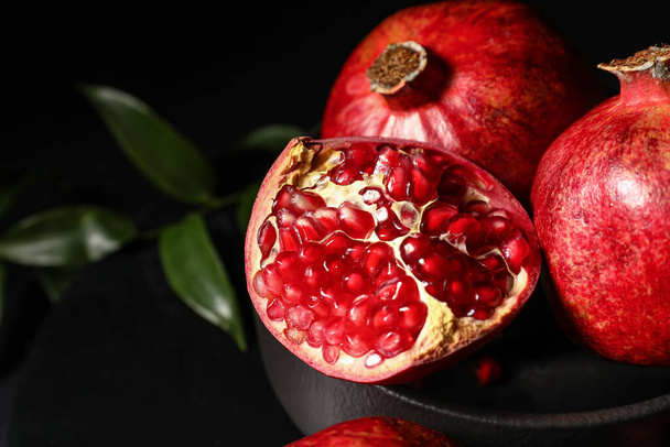 Ripe delicious pomegranate on dark background - Photo, Image