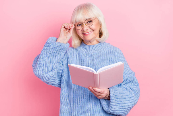 Photo of lovely granny read book fairytale her grandchild eyewear isolated over pink color background - Фото, изображение
