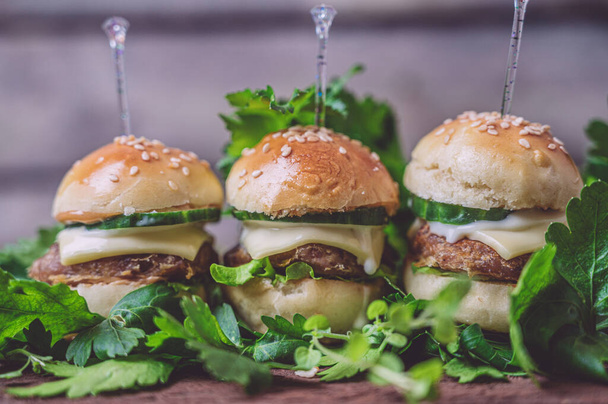 Close up of mini beef burgers isolated on wood background - Foto, immagini