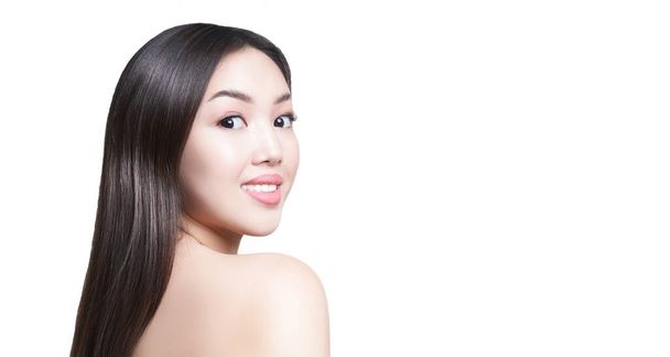 Portrait of a young Asian girl. On an isolated white background with a place to copy. The concept of skin and hair care - Фото, изображение