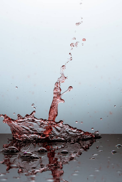 wine splash on gray background close up - Photo, image