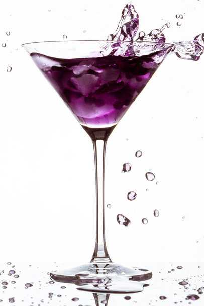 purple cocktail in glass on white - Фото, изображение
