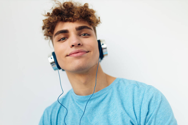 handsome guy in blue t-shirts headphones fashion Lifestyle unaltered - Фото, изображение