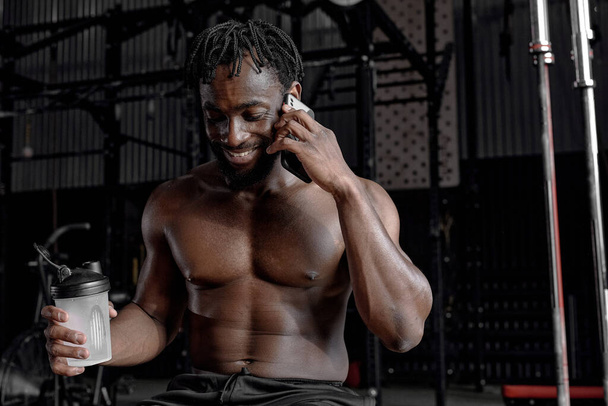 Relaxed Afro American Man Talking On Phone, Having Rest Affter Training At Gym - Φωτογραφία, εικόνα