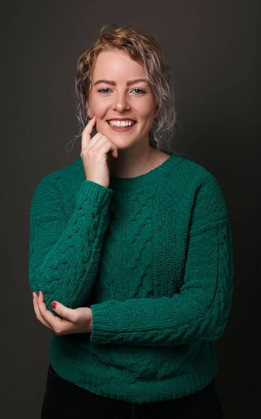 Portrait of a beautiful happy woman in front of a colored background - Valokuva, kuva