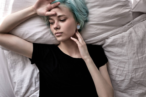 top view on uphappy female lying on bed, depressed upset woman at home alone - Fotoğraf, Görsel