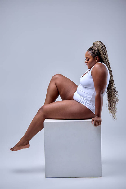 overweight female on white background in studio, plus size model in bodysuit, fat body - Foto, Imagem
