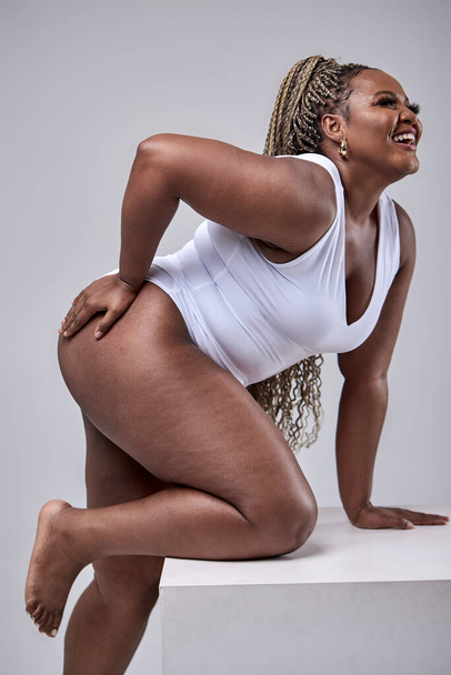 Fat lady on white background in studio, plus size model in bodysuit, beautiful female body - Foto, afbeelding