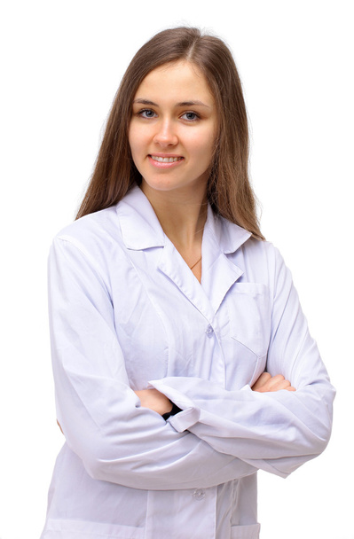 Portrait of happy young doctor woman standing with arms crossed isolated on - 写真・画像