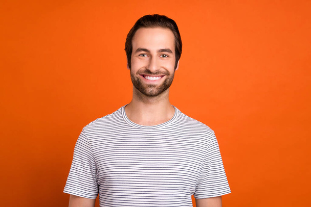 Photo of young cheerful guy toothy smile visit clinic oral care caries isolated over orange color background - 写真・画像
