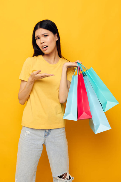 pretty brunette woman with packages in hands shopping isolated background unaltered - Photo, Image