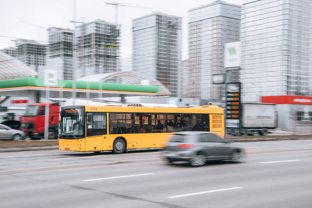 Ucrânia, Kiev - 15 de janeiro de 2022: Carro de ônibus de transporte público amarelo se movendo na rua. Editorial - Foto, Imagem