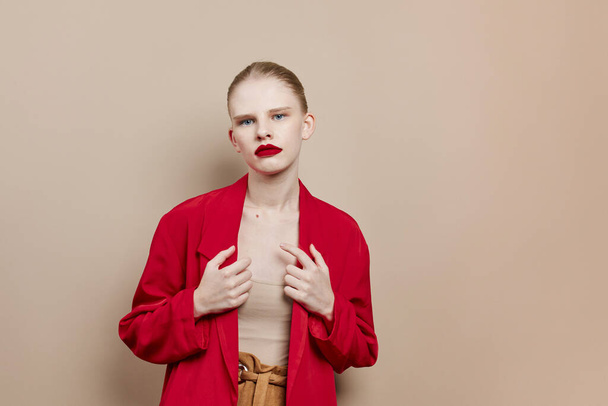 fashionable woman red lips fashion jacket beige background - Foto, imagen