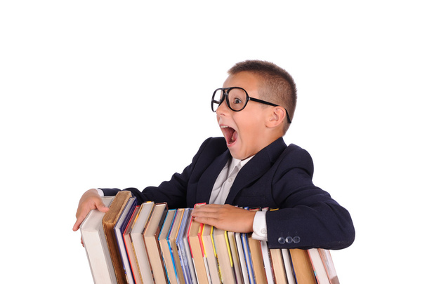 Schoolboy screaming near the huge stack of books - Foto, Imagem