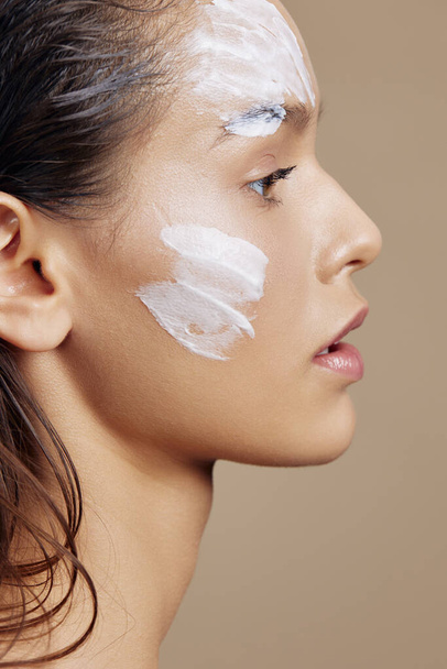 woman hand near face cream rejuvenation charm Youth and Skin Care Concept - 写真・画像