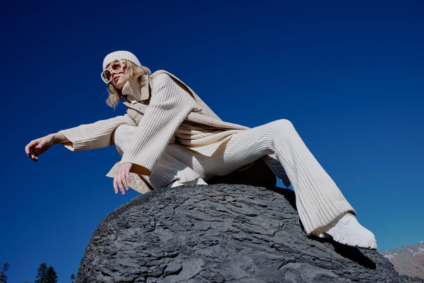 turista en ropa de otoño se encuentra en un paisaje de roca cielo azul relajación - Foto, Imagen