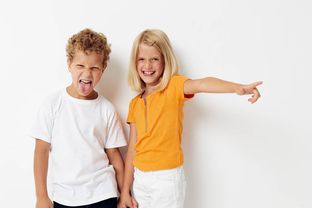 picture of positive boy and girl casual clothes posing emotions studio isolated background unaltered - Fotoğraf, Görsel