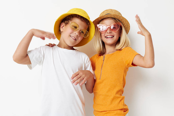 boy and girl wearing hats fashion glasses posing friendship fun - Foto, imagen