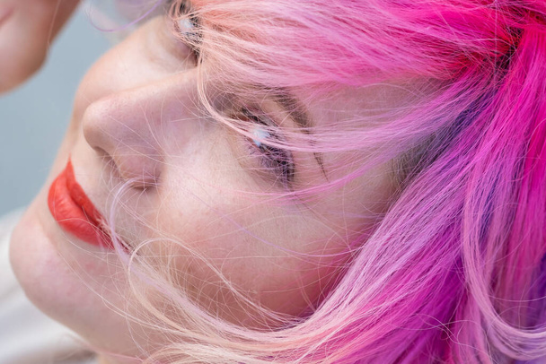 Close-up portrait of curly Caucasian woman with multi-colored hair. Model for hairstyles - Photo, image