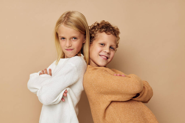 Portrait of cute children hug entertainment posing friendship beige background - Fotoğraf, Görsel