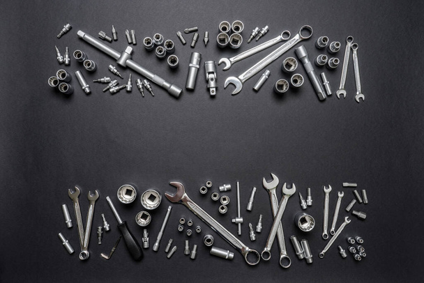 Tool set on black background. Mechanic tools, wrenches or spanners. Technique repair, equipment for mechanical service, labor or father's day concept. Flat lay, top view, copy space. - Фото, зображення