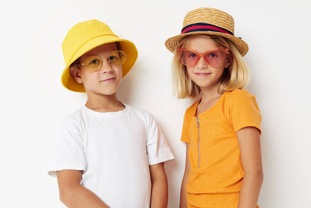 boy and girl wearing hats fashion glasses posing friendship fun - Valokuva, kuva