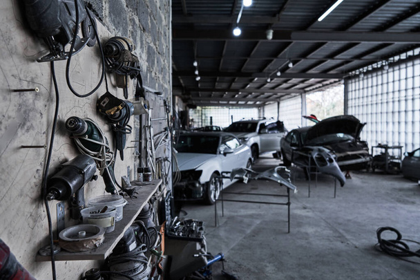 Tools in car service, equipment for restoration and fixing car in garage - Foto, Imagem