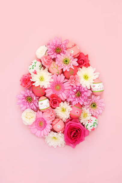 Húsvéti tojás alakú koncepció díszített tojás és virágok pasztell rózsaszín háttér. Tavaszi és húsvéti absztrakt design. Felülnézet, másolás. - Fotó, kép