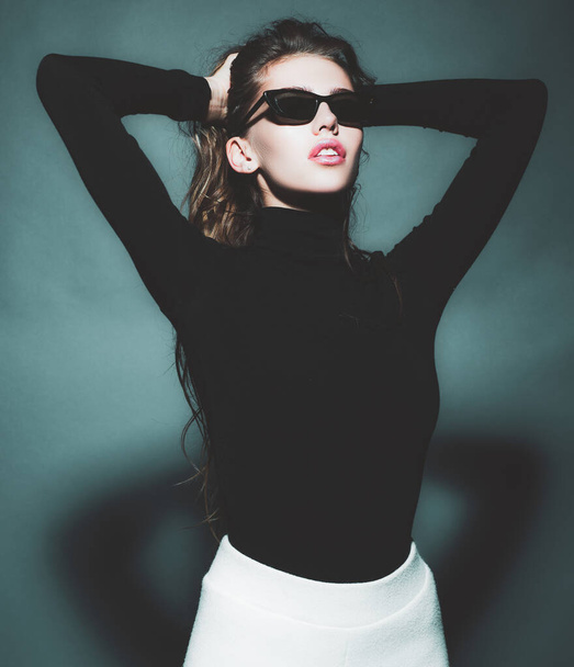 Sexy woman in black sunglasses. Portrait of sensual girl looking away isolated on gray. - Фото, изображение