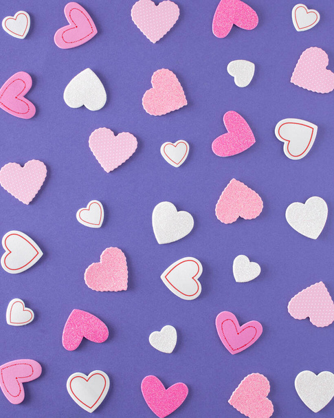 Romantic pattern made of white and pink hearts. Minimalist concept on blue backgrounds - Photo, Image