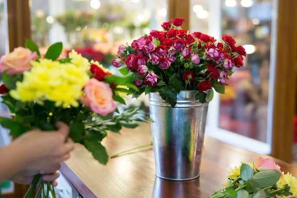 Workshop florist, making bouquets and flower arrangements. Woman collecting a bouquet of flowers. - Φωτογραφία, εικόνα