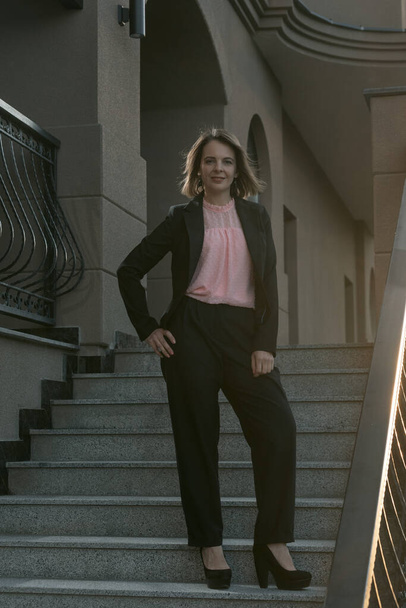 Successful business woman in a stylish suit on the stairs of a building. Businesswoman. Full-length portrait. - Photo, Image