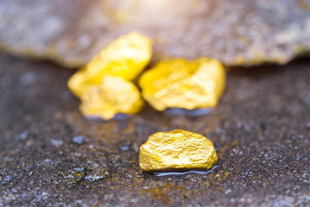 Gold on the stone floor Discovering Success and Investing Concepts with Business Partners. - Photo, Image